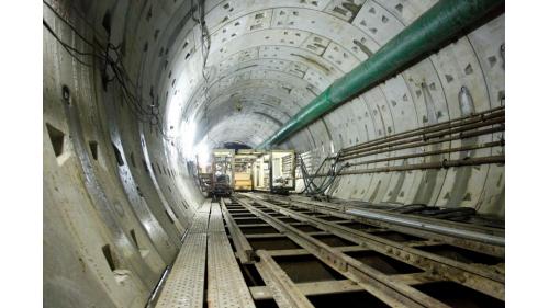 機場捷運台北車站至三重站間因隔了淡水河，施工團隊以潛盾隧道穿越河床，除考量淡水河兩側堤防與環快高架橋基樁衝突等問題外，尚須設置連絡通道，以符合隧道安全及維修之需求，因而採用雙圓形潛盾隧道(DOT)工法施工。