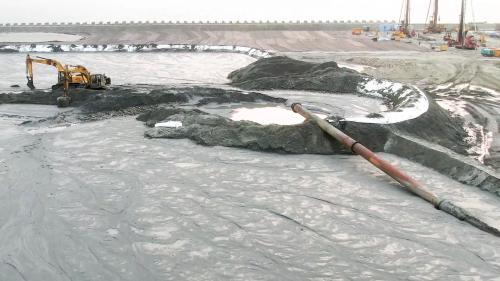 台北港以挖掘航道產生的砂石做為填海造地建港的建材。